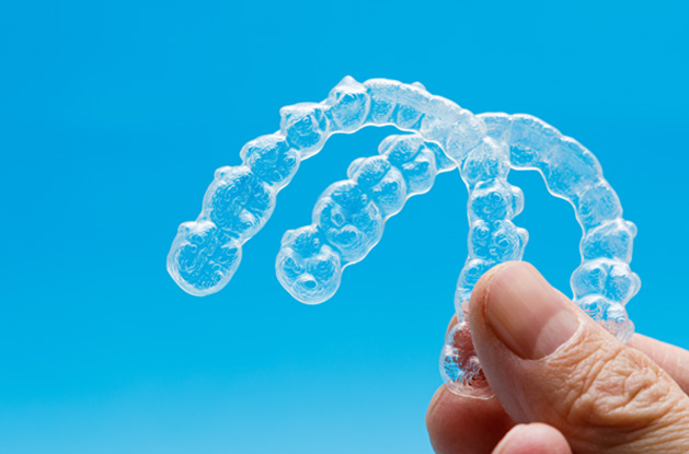 a close-up of two Invisalign aligners