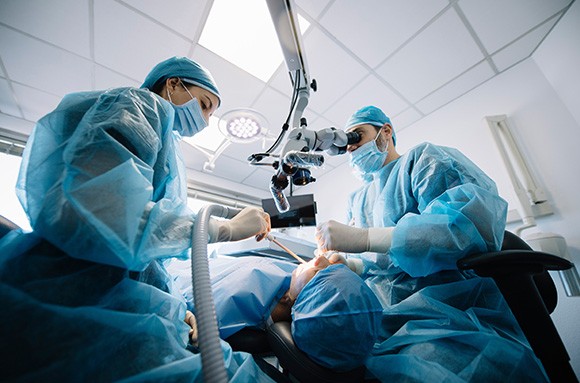 Dentists performing a dental implant surgery