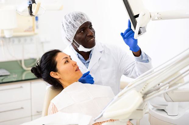 Dentist and dental patient looking at computer monitor