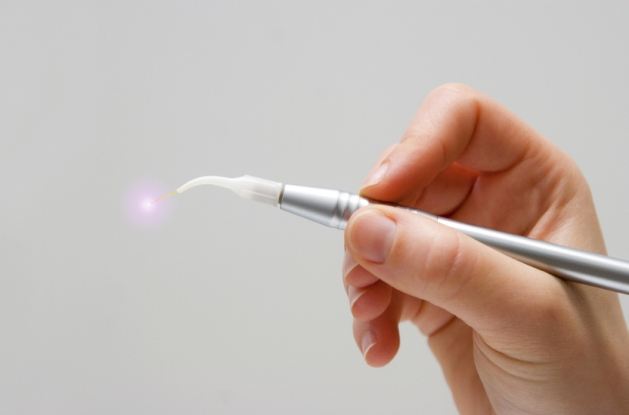 Hand holding a thin metal soft tissue laser